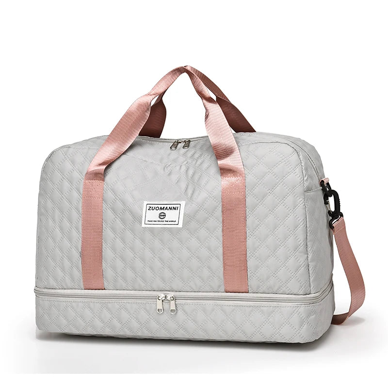Gray duffel bag with pink straps on a white background