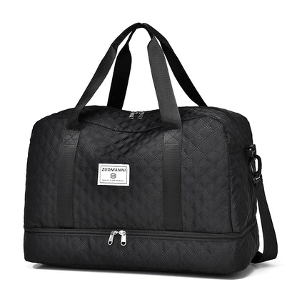 Black quilted duffel bag with a visible brand logo on a white background