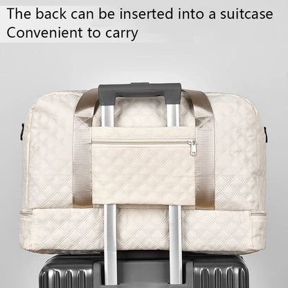 Beige quilted bag with handle attached to a suitcase on a gray background