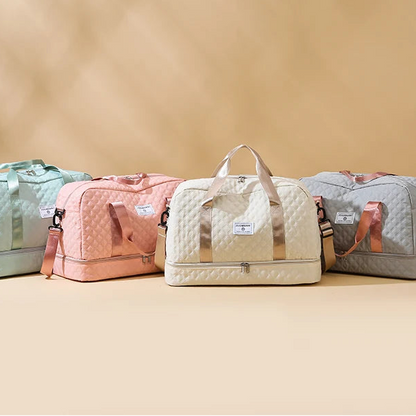 Four quilted duffel bags in different colors on a beige background