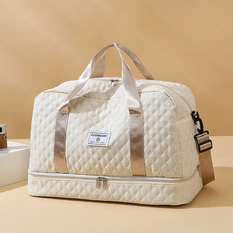 Beige quilted duffel bag with a visible brand label on a beige background