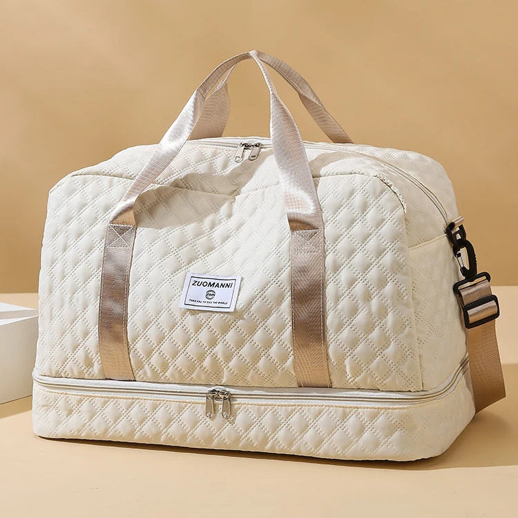 Quilted beige duffel bag with visible brand label on a beige background
