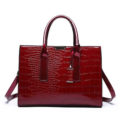 Red crocodile-patterned handbag on a white background