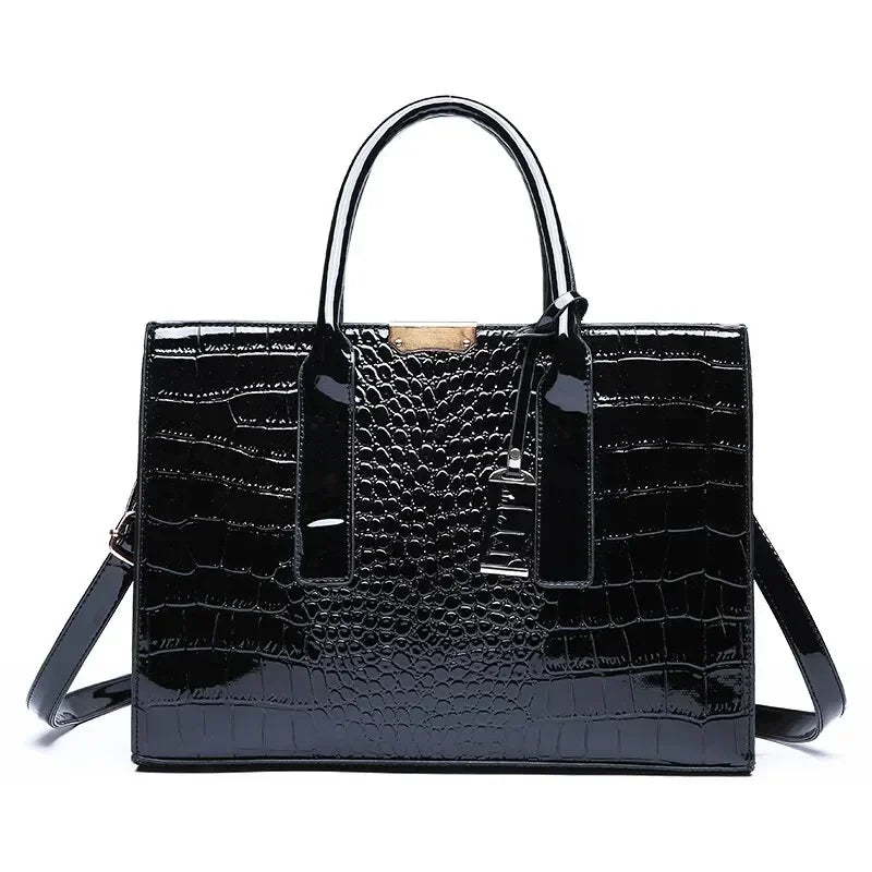 Black crocodile-patterned handbag on a white background