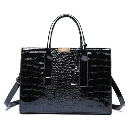 Black crocodile-patterned handbag on a white background