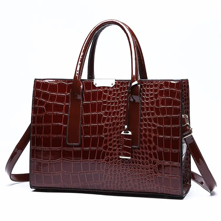 Brown crocodile-patterned handbag on a white background
