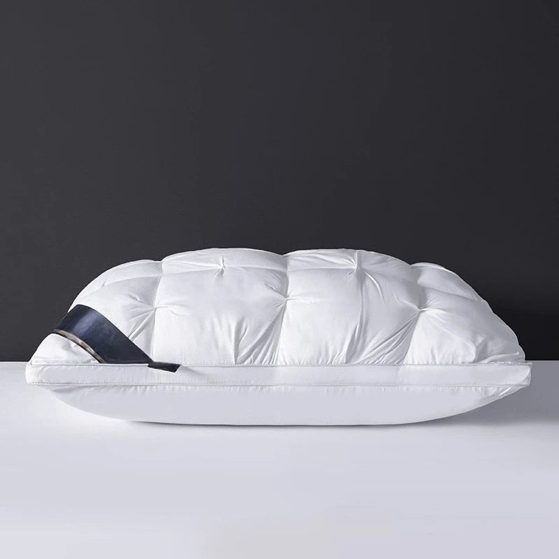 White quilted bag with a black strap on a gray surface and dark background