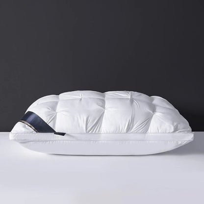 White quilted bag with a black strap on a gray surface and dark background