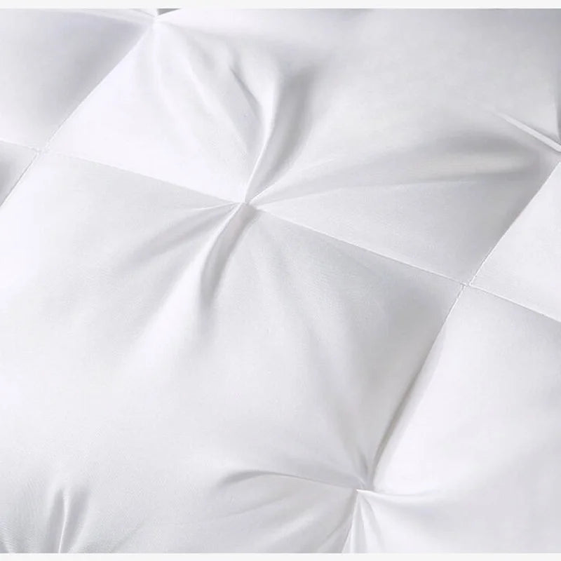 Close-up of a white comforter with a quilted pattern