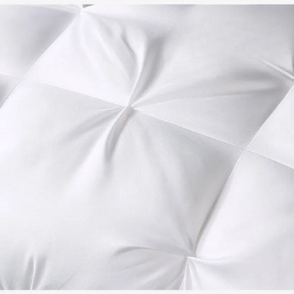 Close-up of a white comforter with a quilted pattern