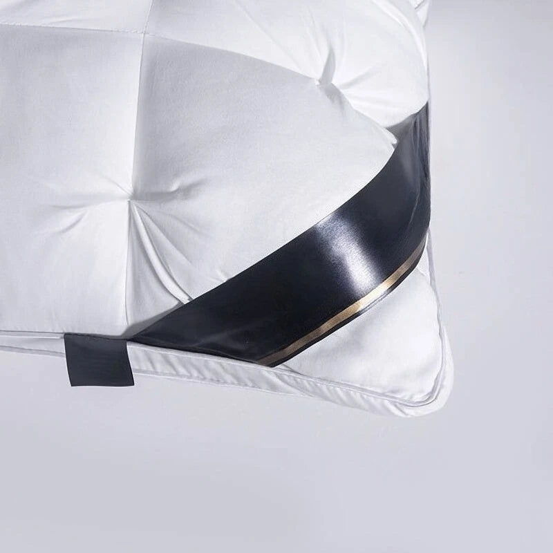 White pillow with a black band on a white background