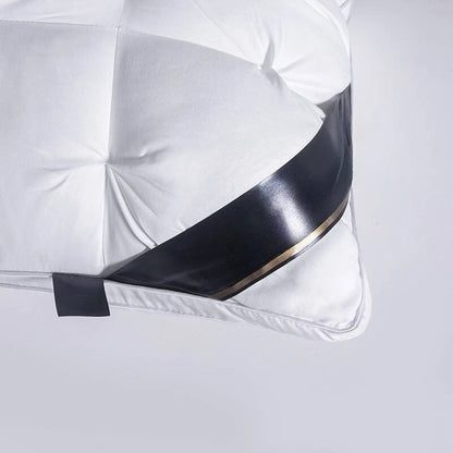 White pillow with a black band on a white background