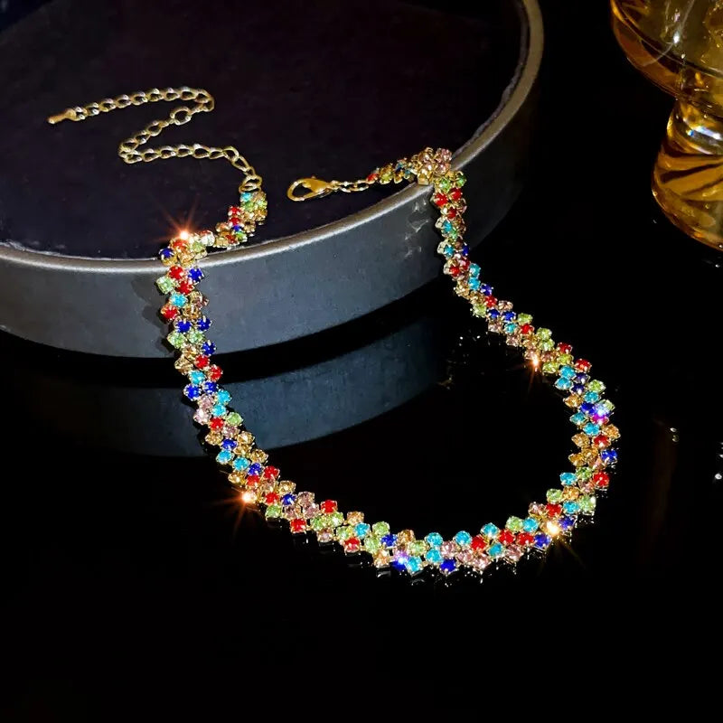 Colorful beaded necklace on a dark surface with a blurred background