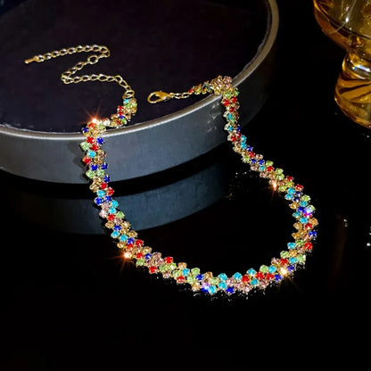 Colorful beaded necklace on a dark surface with a blurred background