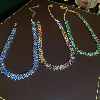Three colorful beaded necklaces on a dark surface