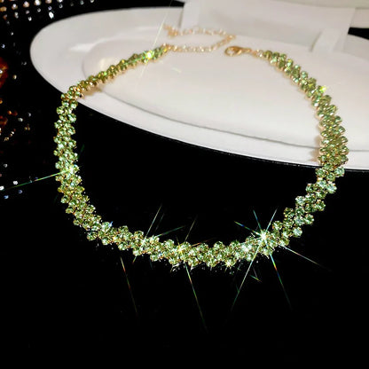 Green beaded necklace on a white stand with a black background