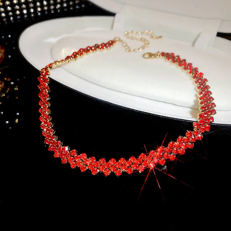 Red beaded necklace on a white box with a black background