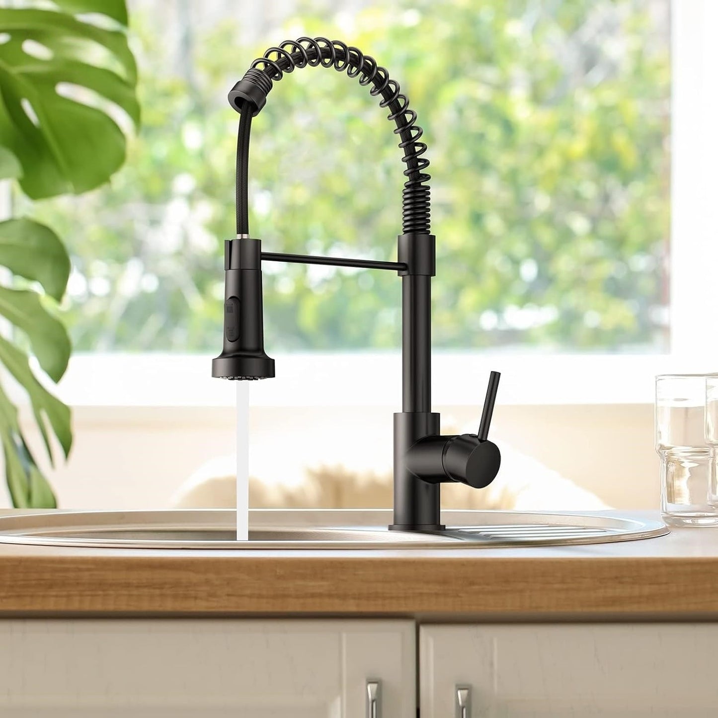 Black kitchen faucet with a modern design in a kitchen setting.