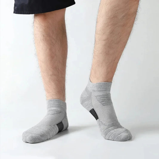 Person wearing gray socks on a white background