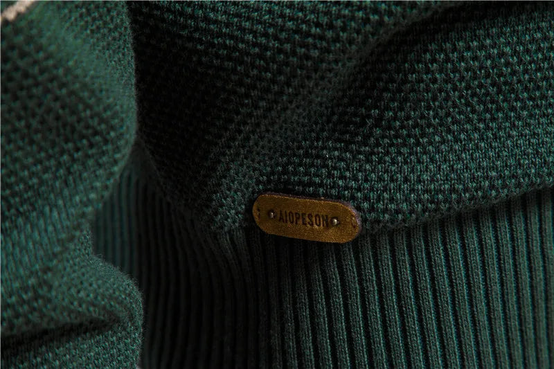 Close-up of a green textured fabric with a brand label on a blurred background