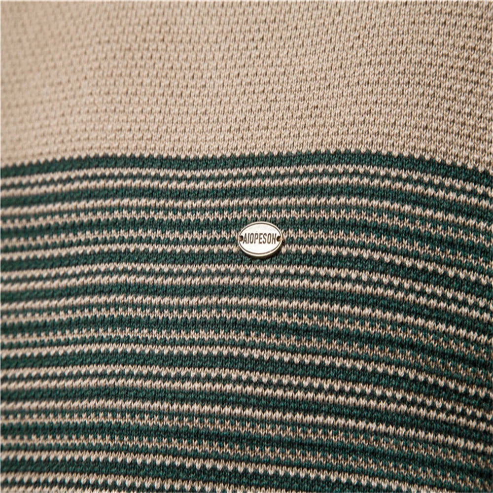 Close-up of a striped fabric with a brand logo in the center.
