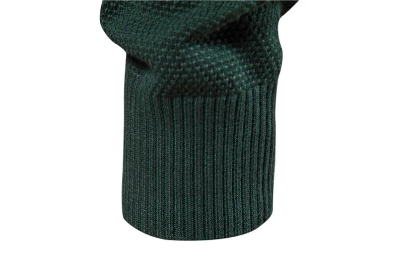 Close-up of a green knitted sweater sleeve on a white background