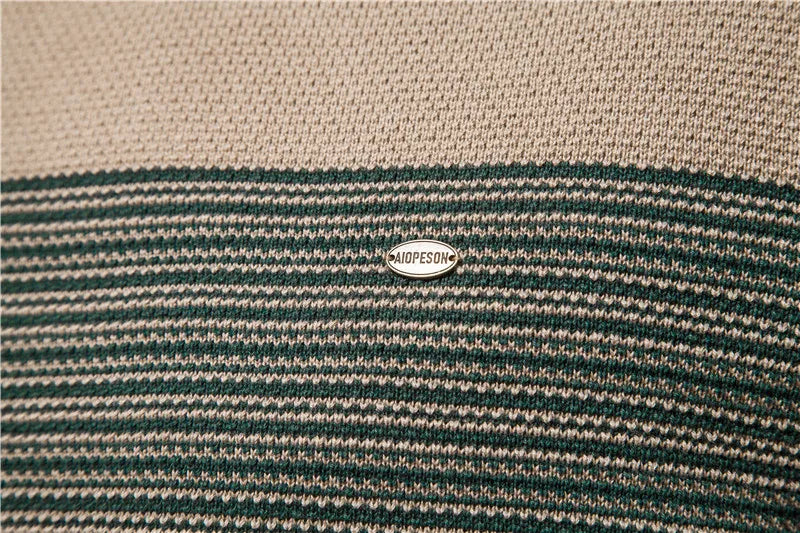 Close-up of a striped fabric with a brand logo in the center.