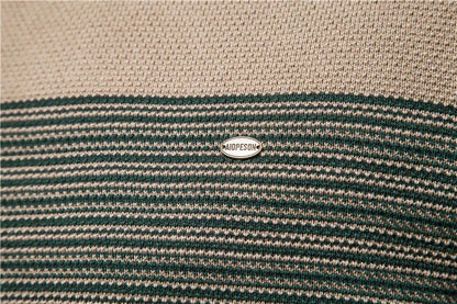 Close-up of a striped fabric with a brand logo in the center.