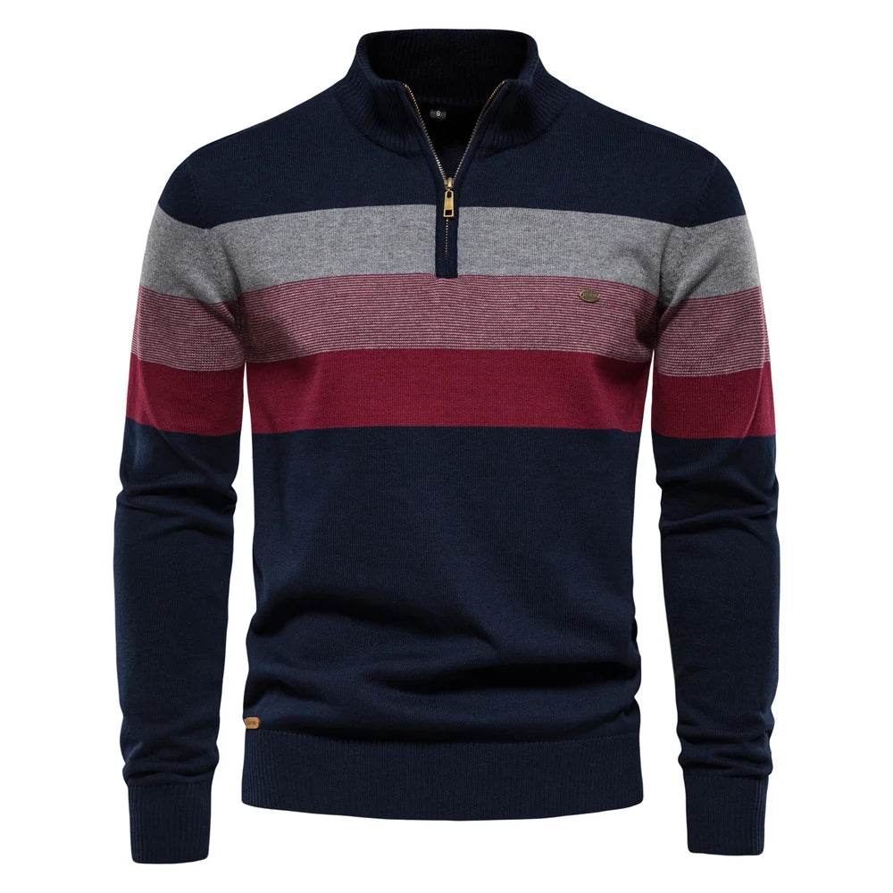 Navy, gray, and red striped sweater with a gold zipper on a white background