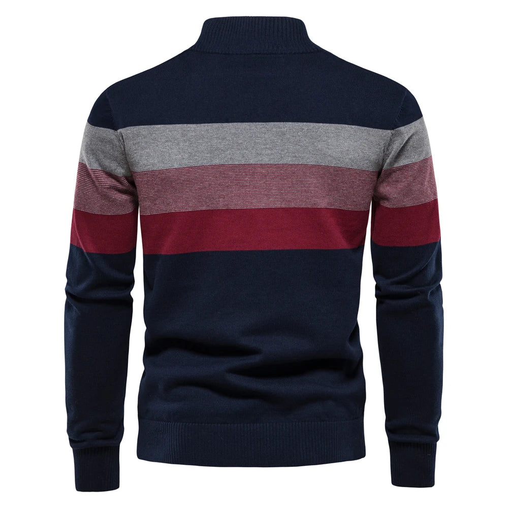 Navy, gray, and red striped sweater on a white background