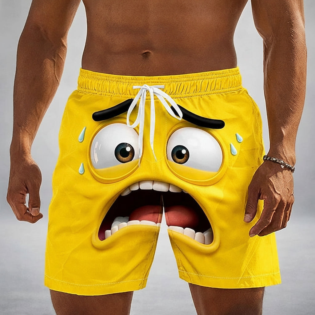 Men's yellow swim trunks with a 3D cartoon face design, shown on a model. The design features a panicked expression with wide eyes, sweat drops, and an open mouth showing teeth and tongue.