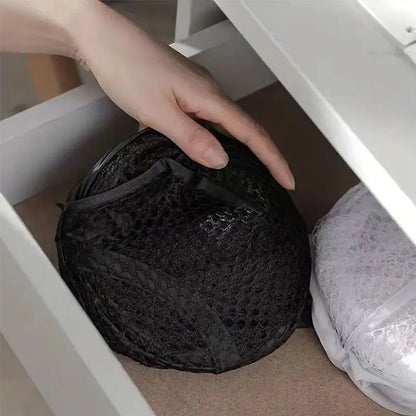 Hand reaching into a drawer to pull out a black lace bralette.