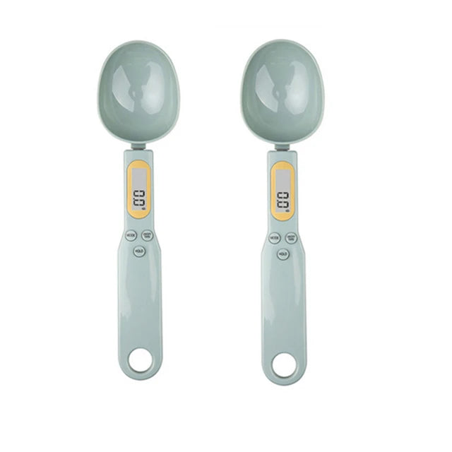 Two digital measuring spoons with gray handles and bowls on a white background