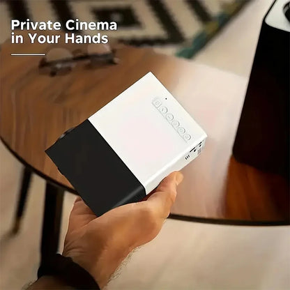 Hand holding a portable device with text 'Private Cinema in Your Hands' on a blurred indoor background