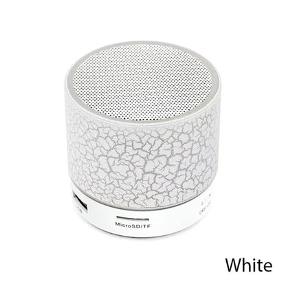 White portable speaker with crumpled paper texture on a white background