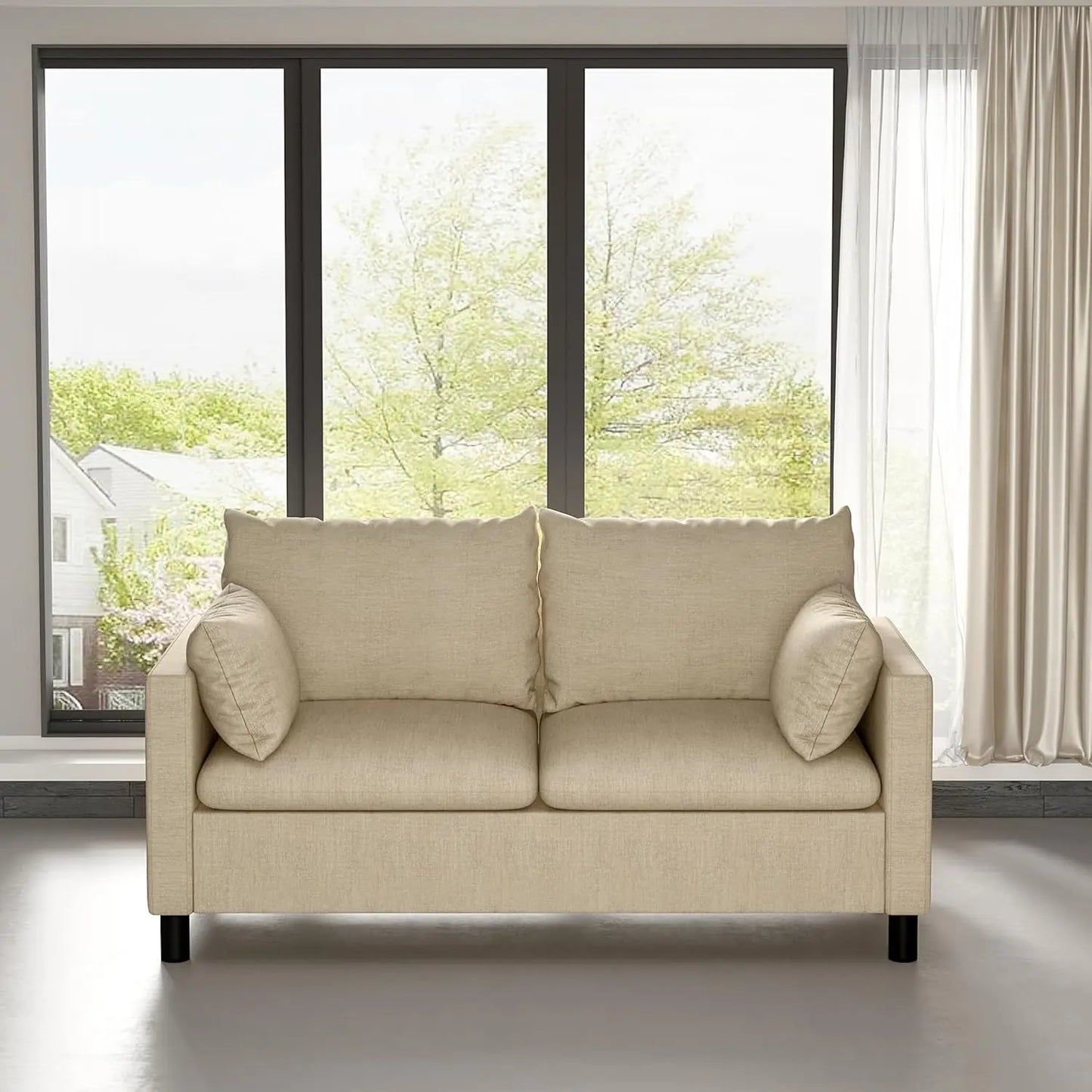 Beige sofa in a room with large windows and curtains