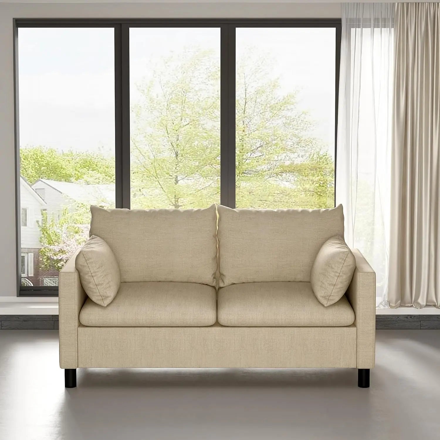 Beige sofa in a room with large windows and curtains