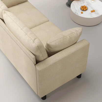 Beige sofa with cushions on a light gray floor.