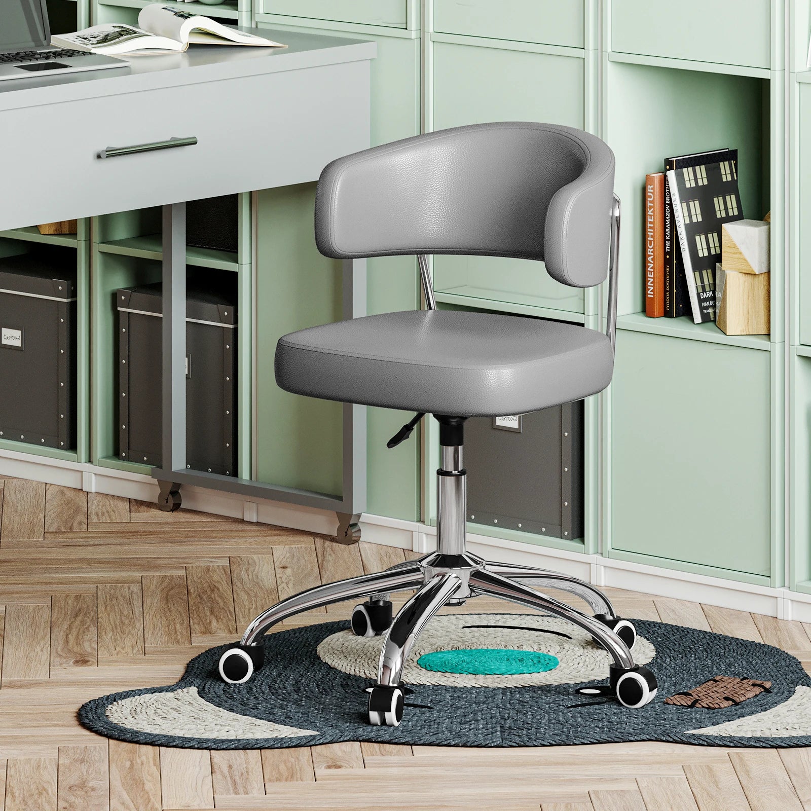 Gray office chair in front of a desk with a green bookshelf in the background.