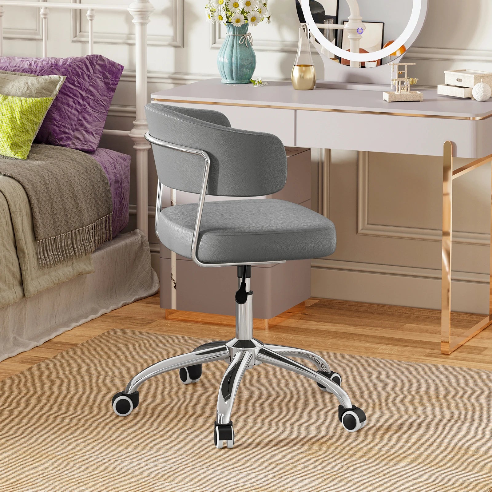 Gray office chair in a room with a desk and decorative items.