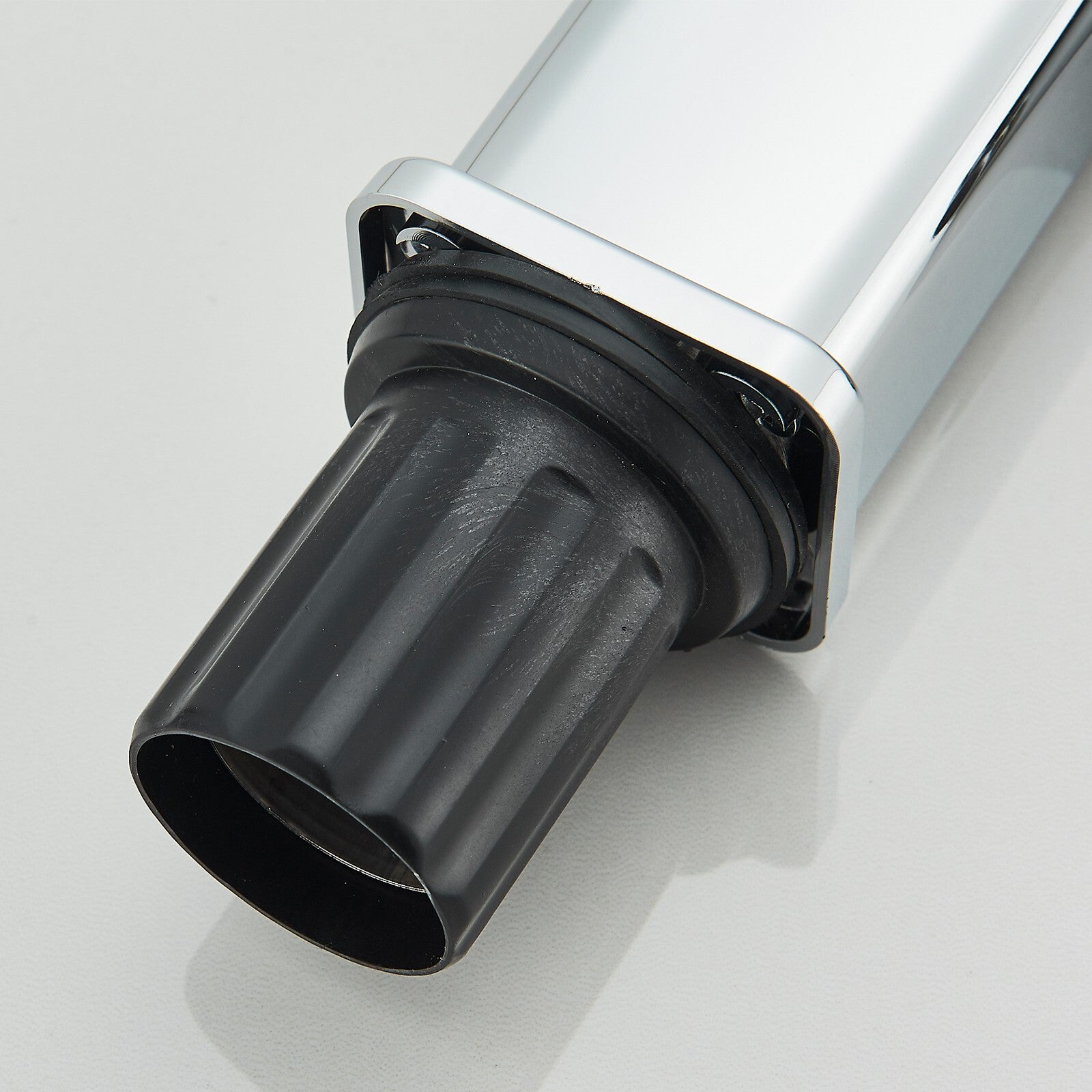 Close-up of a black exhaust pipe on a white background