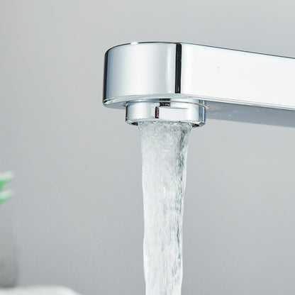 Chrome faucet with water flowing against a light gray background