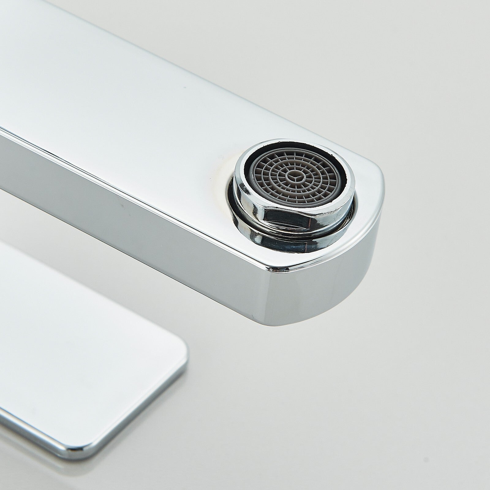 Chrome kitchen faucet on a light gray background