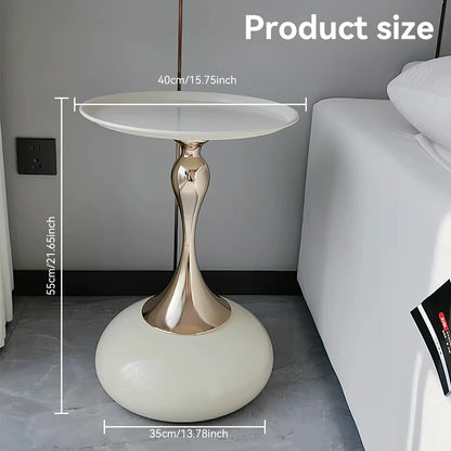 Small round table with measurements next to a sofa