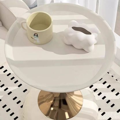Small round white table with a beige cup and white rabbit-shaped object on a checkered floor.