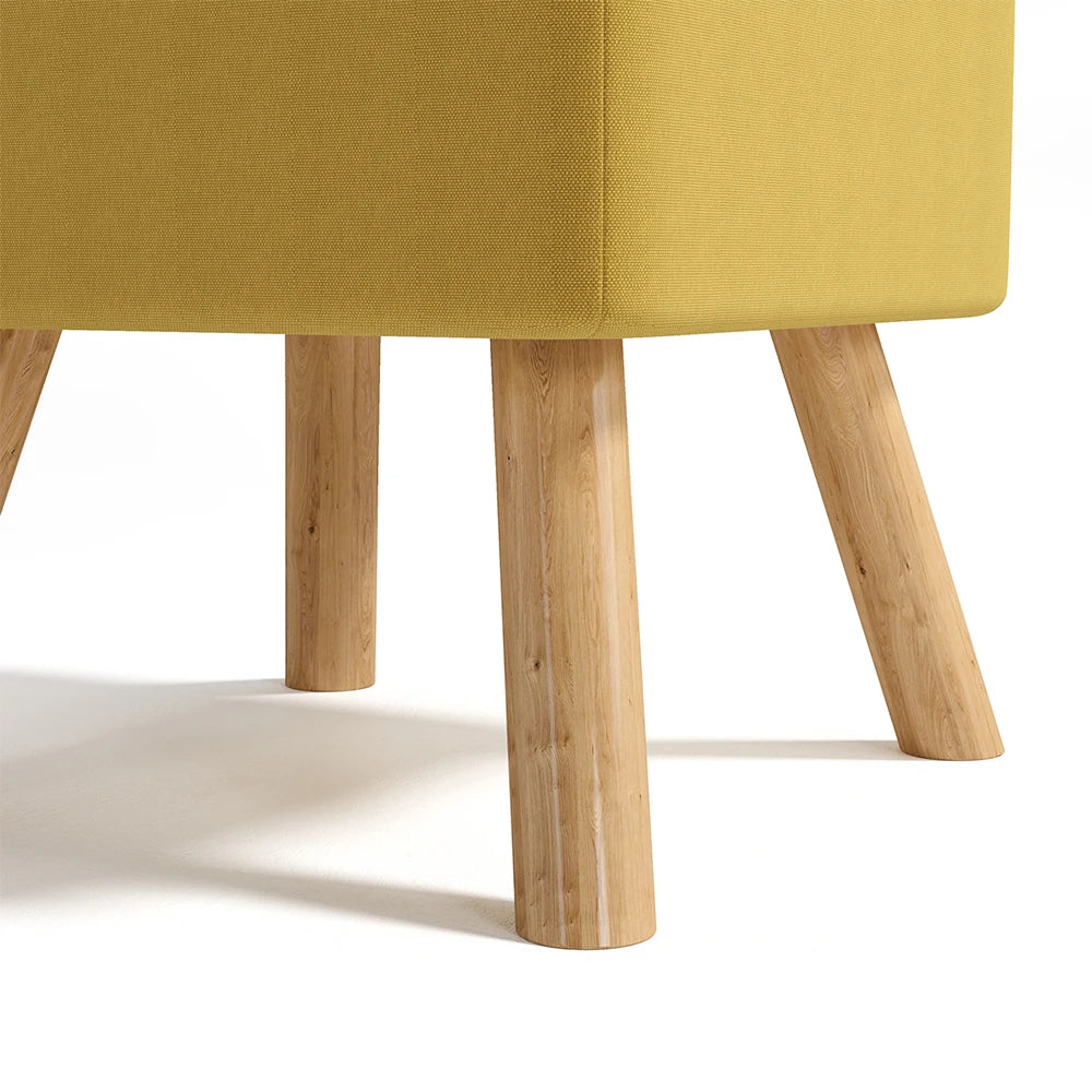 Yellow upholstered chair with wooden legs on a white background