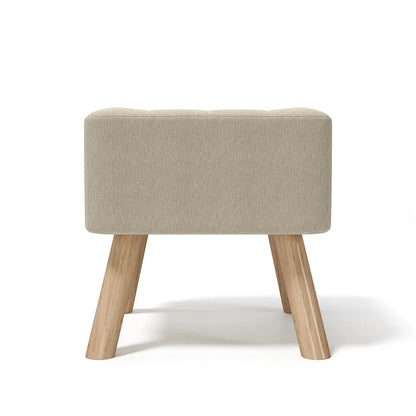 Beige ottoman with wooden legs on a white background