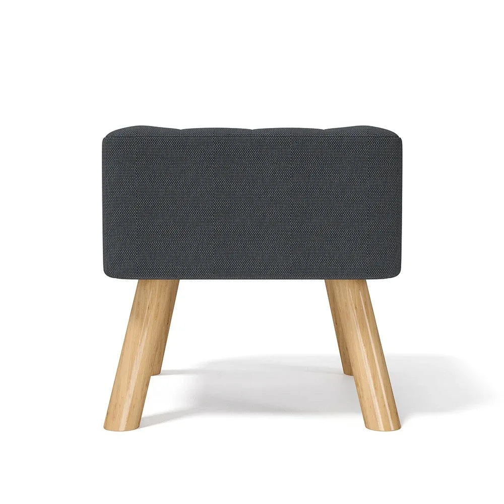Gray upholstered stool with wooden legs on a white background