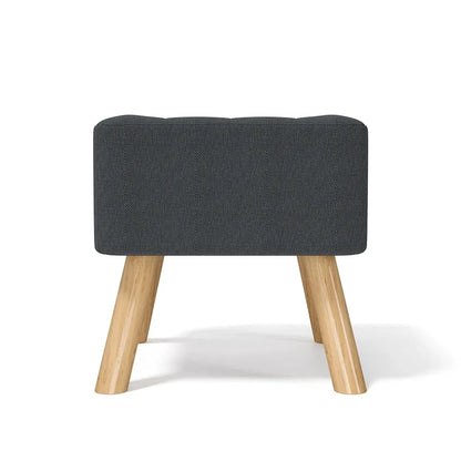 Gray upholstered stool with wooden legs on a white background