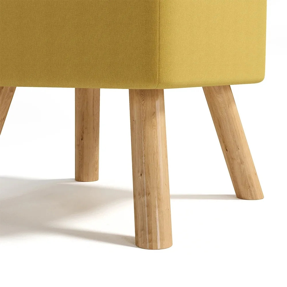 Close-up of a yellow upholstered chair with wooden legs on a white background
